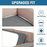 Two grey jacquard stretch sofa seat cushion covers laid flat showing textured twill pattern and elastic loops underneath - view 6