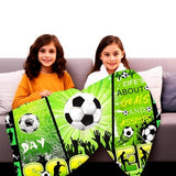 Green flannel throw blanket 60x80 inches with all-over soccer ball print, folded on a sofa, soft anti-pill fabric - view 3