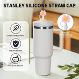 Eight hot pink star-shaped silicone straw covers displayed near Stanley tumblers, dust-proof reusable straw toppers - view 4