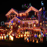 HISHINY 32ft multicolor LED icicle Christmas lights with 72 hanging drops displayed outdoors on roofline at night - view 4