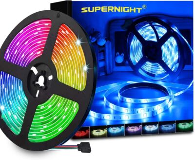 Supernight 32.8ft RGB LED strip lights with 300 LEDs glowing in multiple colors mounted behind a bedroom TV