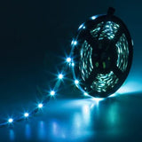 Supernight 32.8ft RGB LED strip lights with 300 LEDs glowing in multiple colors mounted behind a bedroom TV - view 5
