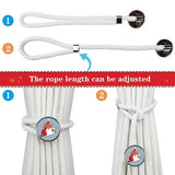 Two white cotton rope curtain tiebacks with handmade Santa Claus patterns, laid flat on a holiday-decorated surface - view 2
