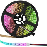 Supernight 32.8ft RGB LED strip lights with 300 LEDs glowing in multiple colors mounted behind a bedroom TV - view 8