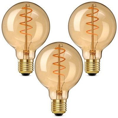 Three G25 amber glass spiral LED Edison bulbs with E26 base standing upright, warm 2000K vintage glow