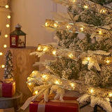Yummuely 33ft gold foil Christmas ribbon fairy lights with 100 warm white LEDs wrapped around a holiday tree - view 6