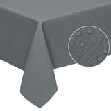 Dark grey rectangular faux linen tablecloth 60x120 inches with pleated corners draped over a dining table, waterproof stain resistant