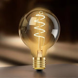 Three G25 amber glass spiral LED Edison bulbs with E26 base standing upright, warm 2000K vintage glow - view 4