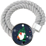 Two gray cotton rope curtain tiebacks with handmade Santa Claus patterns tied around sheer curtain panels