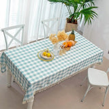 Aqua and white buffalo plaid cotton tablecloth with corner tassels on a large rectangular dining table, 55x102 inches - view 6
