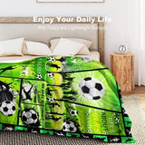 Green flannel throw blanket 60x80 inches with all-over soccer ball print, folded on a sofa, soft anti-pill fabric - view 6