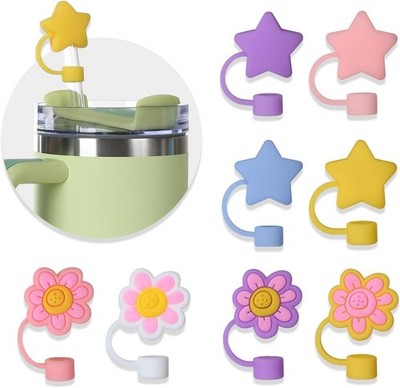 Eight hot pink star-shaped silicone straw covers displayed near Stanley tumblers, dust-proof reusable straw toppers