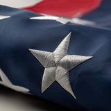 1x1.5 foot outdoor embroidered American flag with brass grommets, vibrant red white and blue colors on display
