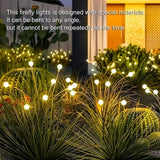 Four Siuholi solar firefly starburst stake lights with warm white LEDs glowing in a garden at night - view 4