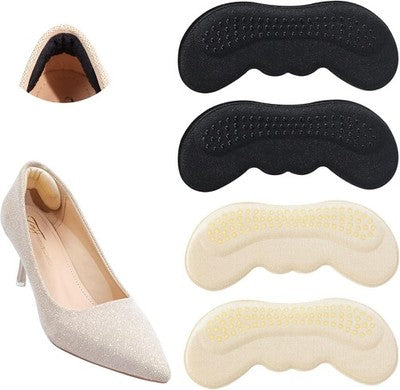 Four OKGL black and yellow self-adhesive heel grip inserts laid flat showing cushioned sponge side and anti-slip surface
