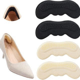 Four OKGL black and yellow self-adhesive heel grip inserts laid flat showing cushioned sponge side and anti-slip surface