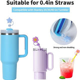 Eight hot pink star-shaped silicone straw covers displayed near Stanley tumblers, dust-proof reusable straw toppers - view 5