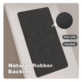 TYUU black 16x24 non-slip bath mat with rubber backing and faux suede surface laid flat on bathroom floor - view 4