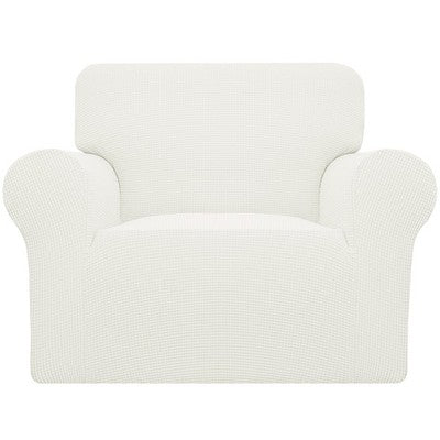 Cream check jacquard stretch slipcover fitted over a standard armchair, showing elastic base and snug one-piece fit