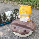 Uniboho kawaii anime cat resin phone stand holding a smartphone upright on a desk with non-slip base - view 6