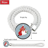 Two white cotton rope curtain tiebacks with handmade Santa Claus patterns, laid flat on a holiday-decorated surface - view 4