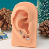 OUFER 3-piece Christmas cartilage stud earrings set featuring Santa hat, shoe, and pine tree designs in surgical steel - view 5