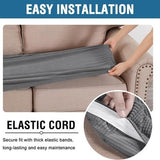 Two grey jacquard stretch sofa seat cushion covers laid flat showing textured twill pattern and elastic loops underneath - view 5