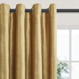 Two gold velvet blackout curtain panels 52x84 inches with silver grommets hanging on a rod in a living room - view 2