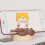 Uniboho kawaii anime cat resin phone stand holding a smartphone upright on a desk with non-slip base - view 2