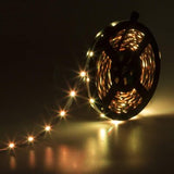 Supernight 32.8ft RGB LED strip lights with 300 LEDs glowing in multiple colors mounted behind a bedroom TV - view 6