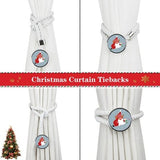 Two white cotton rope curtain tiebacks with handmade Santa Claus patterns, laid flat on a holiday-decorated surface - view 3