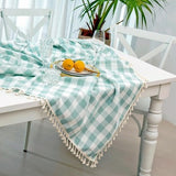 Aqua and white buffalo plaid cotton tablecloth with corner tassels on a large rectangular dining table, 55x102 inches - view 3