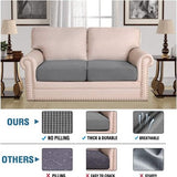 Two grey jacquard stretch sofa seat cushion covers laid flat showing textured twill pattern and elastic loops underneath - view 2