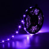 Supernight 32.8ft RGB LED strip lights with 300 LEDs glowing in multiple colors mounted behind a bedroom TV - view 7