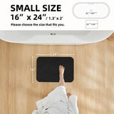 TYUU black 16x24 non-slip bath mat with rubber backing and faux suede surface laid flat on bathroom floor - view 2