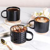 Set of 4 stackable black textured ceramic coffee mugs 12oz arranged in a stack on a white surface - view 6