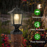 Two matte black solar post cap lights with glass shades mounted on 4x4 wood fence posts glowing warm white LED light - view 4