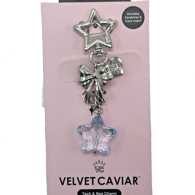 Velvet Caviar silver star carabiner clip charm with metallic bow and light blue faceted crystal star pendant