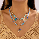 IQIC two-layer boho beaded necklace with cowrie shell and starfish charms, blue beads and gold-tone accents on white background - view 2
