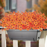 Seven 13-inch orange artificial fall flower stems with 20 flowerheads displayed in a decorative outdoor arrangement - view 7