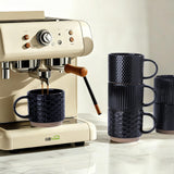 Set of 4 stackable black textured ceramic coffee mugs 12oz arranged in a stack on a white surface - view 5