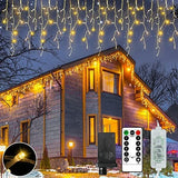 Warm white LED icicle lights with 72 hanging drops strung along a roofline outdoors, Christmas icicle lights 360 LED 18.57ft