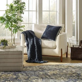 Threshold Studio McGee 20x20 inch navy blue throw pillow with cream woven border and side tassels on sofa - view 4