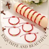 Set of 20 red and gold cord Saint Benedict medal bracelets with S-hook clasp displayed on a flat surface - view 2