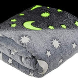 Grey fleece throw blanket with glow-in-the-dark stars and moons pattern, 50x60 inches, folded on white background