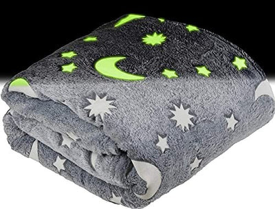 Grey fleece throw blanket with glow-in-the-dark stars and moons pattern, 50x60 inches, folded on white background
