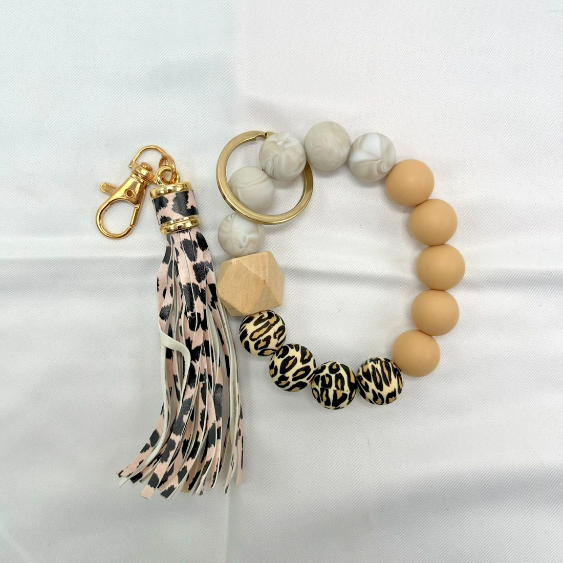 Silicone beaded wristlet keychain bracelet set in cheetah print, marble, and tan patterns with gold-tone key ring