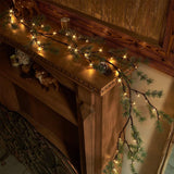 Fudios 6-foot lighted Christmas pine garland with 48 warm white LED lights draped over a fireplace mantel indoors - view 4