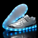 Silver kids LED light-up sneakers with hook and loop closure, size 1, shown from side angle highlighting sole lighting - view 5