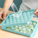 Two round sphere ice ball maker trays with lids in pink and blue BPA-free plastic for whiskey and cocktails - view 4